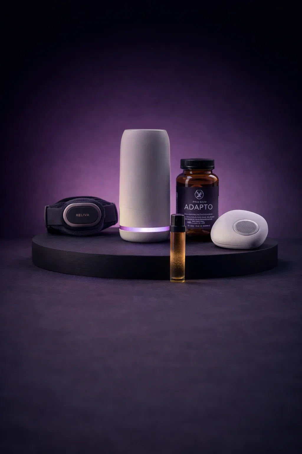 Stress regulation kit with wearable tracker, supplement bottle, diffuser, and oil vial on purple background