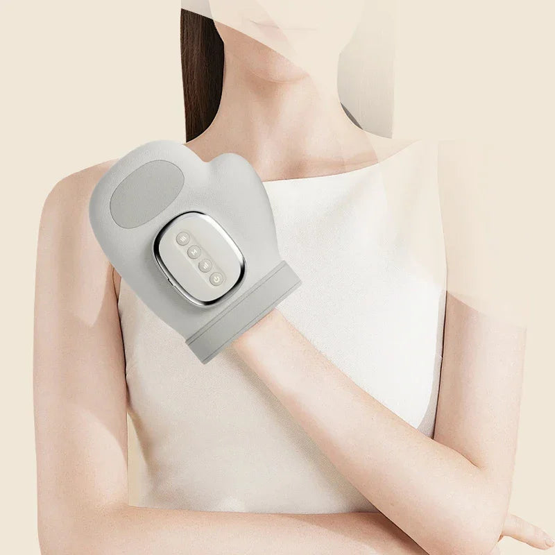 Woman wearing a gray wearable hand massager with control panel on wrist